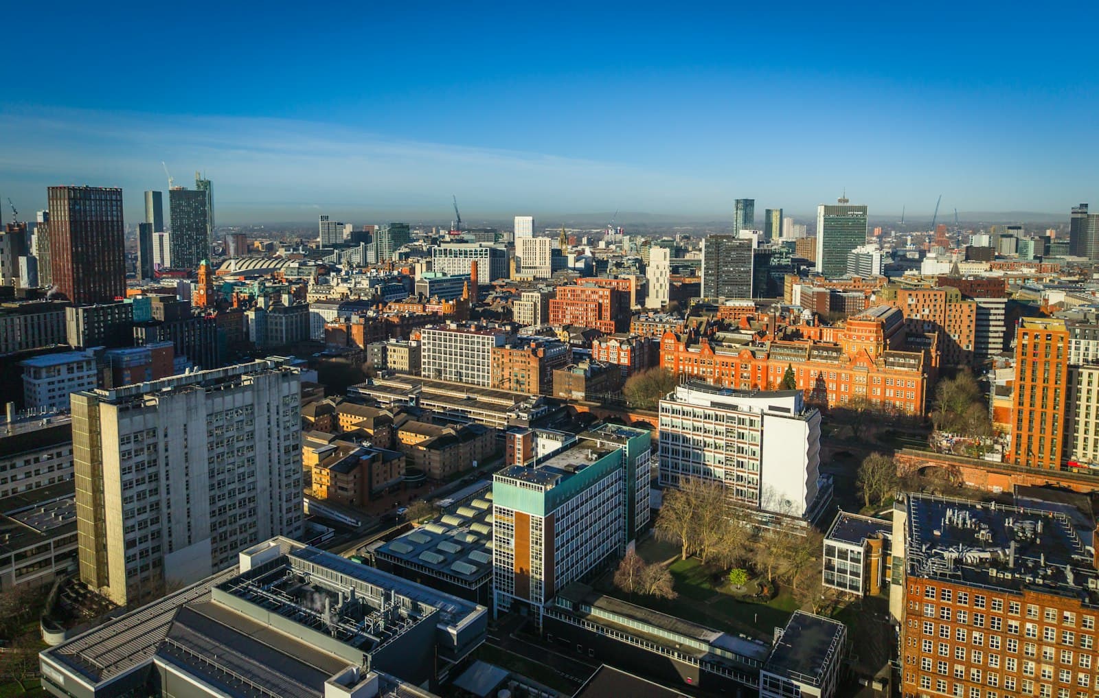 Aerial view across a city centre in warm evening light