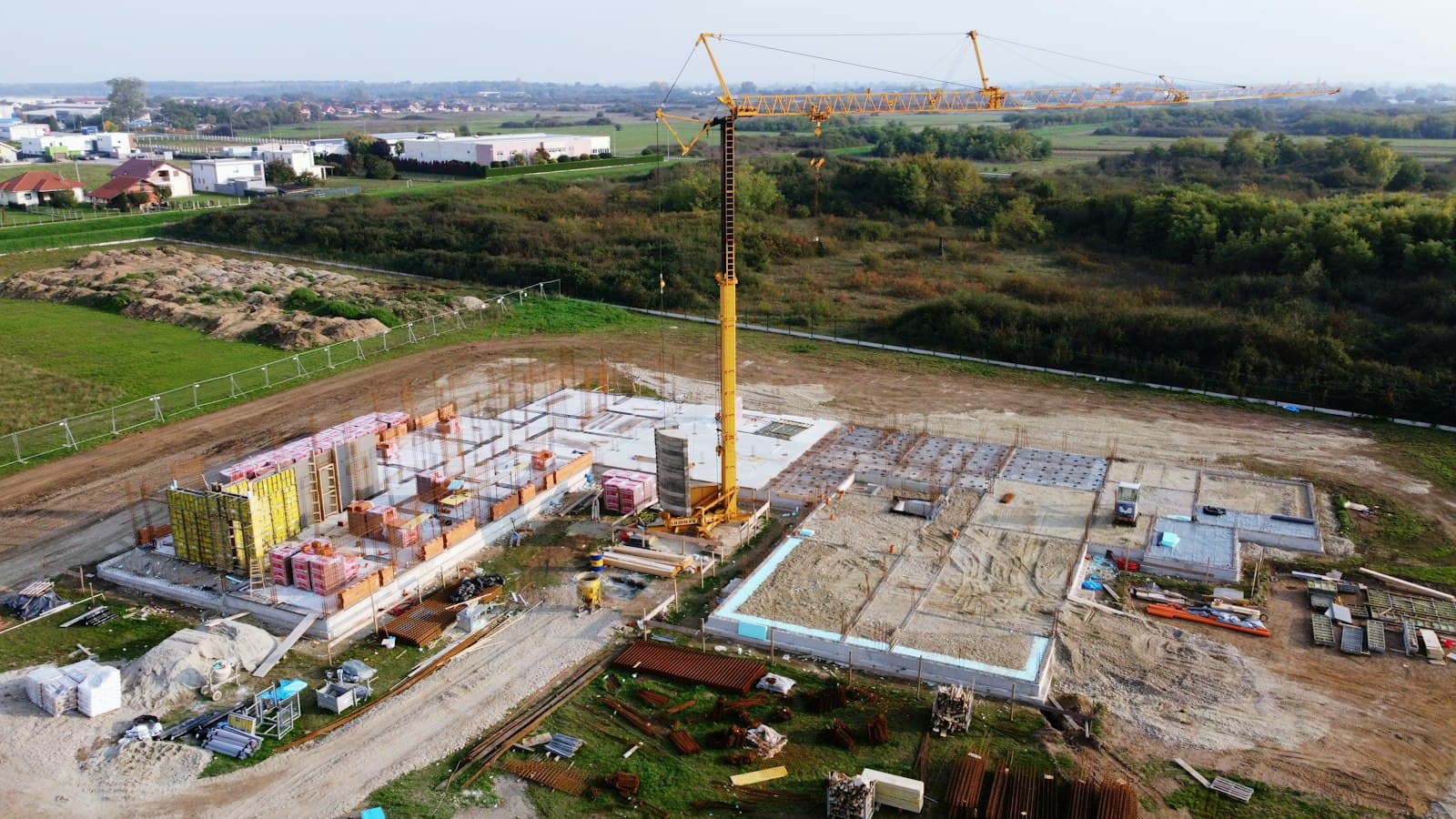 Wide drone photograph of groundworks and foundations on a building site