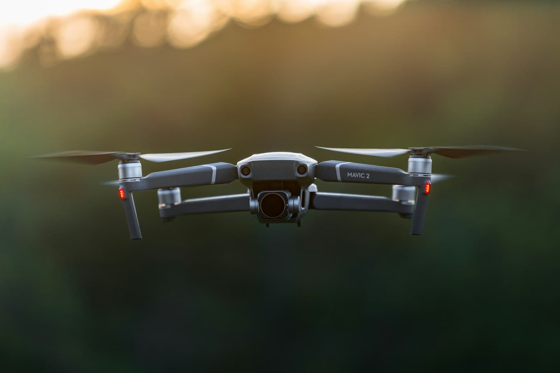 A professional camera drone hovering at dusk