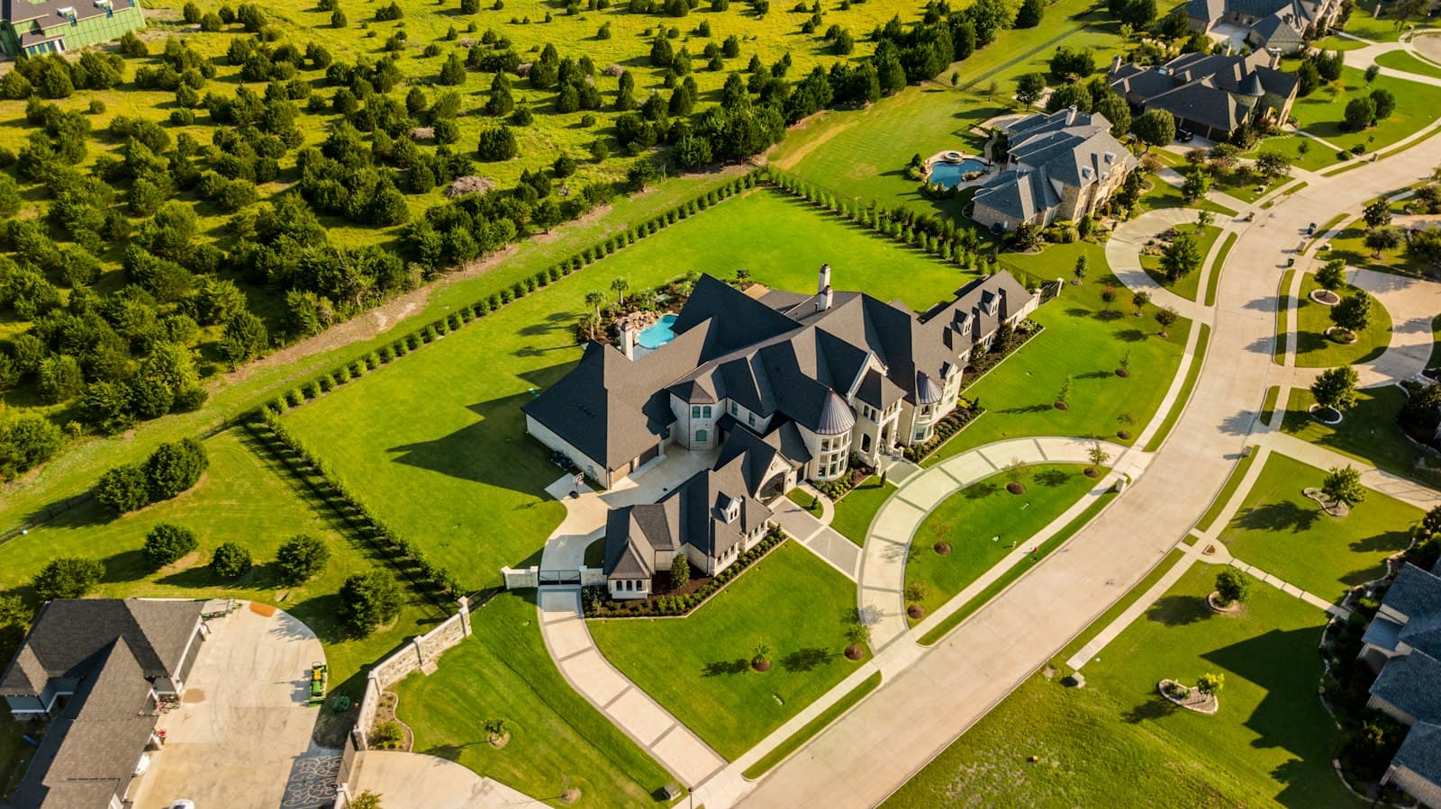 Drone photograph of a large home set within landscaped grounds